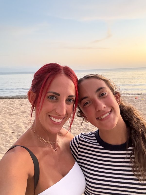 Cheyenne and her daughter at the beach at sunset